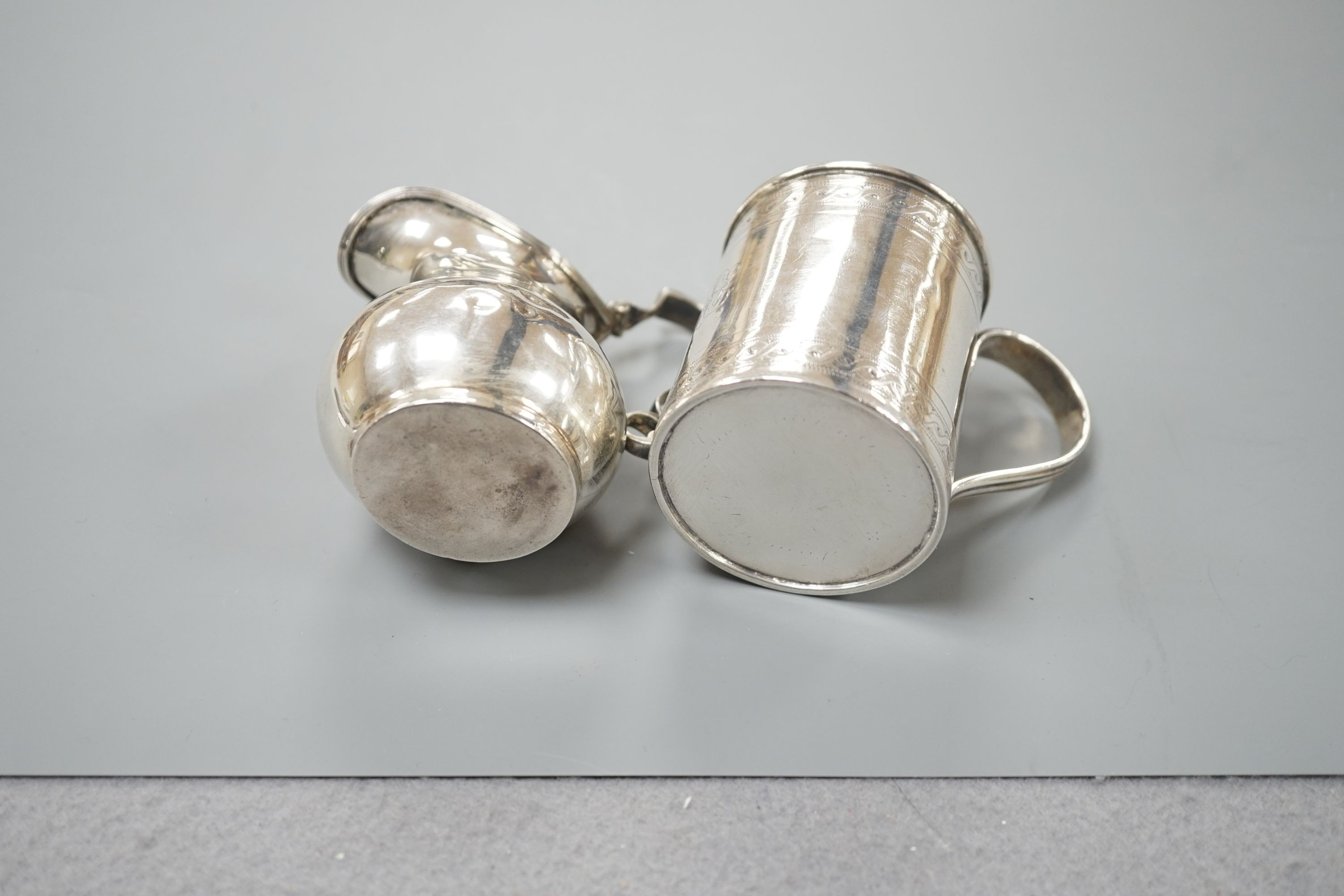 A George III engraved silver christening mug, London, 1810, 67mm and a later silver cream jug, 5oz.